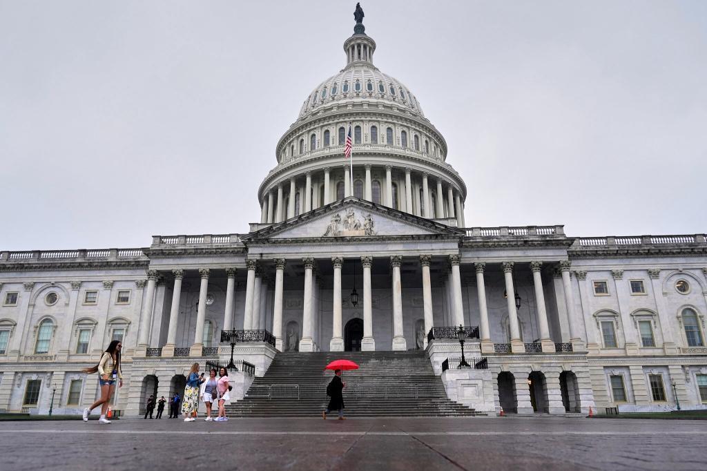 Visitors walk in-front of the U.S Capitol.