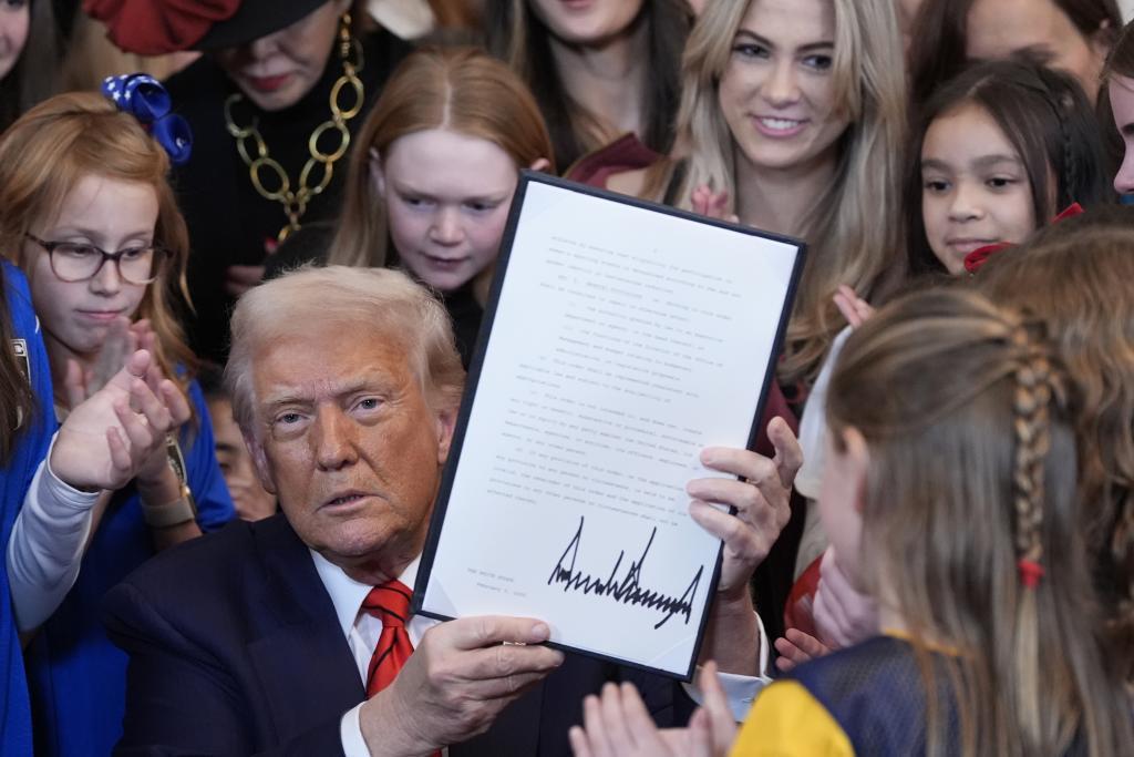President Donald Trump signs an executive order barring transgender female athletes