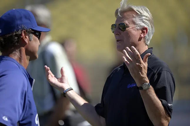 Mark Walter speaks with team manager Don Mattingly.