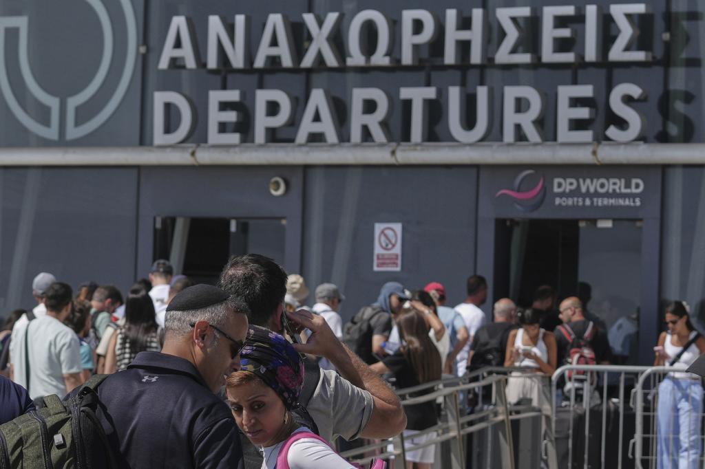 Israelis line up at the entrance to the departures terminal at Cyprus' main port in Limassol where they'll board the Israeli cruise ship Crown Iris
