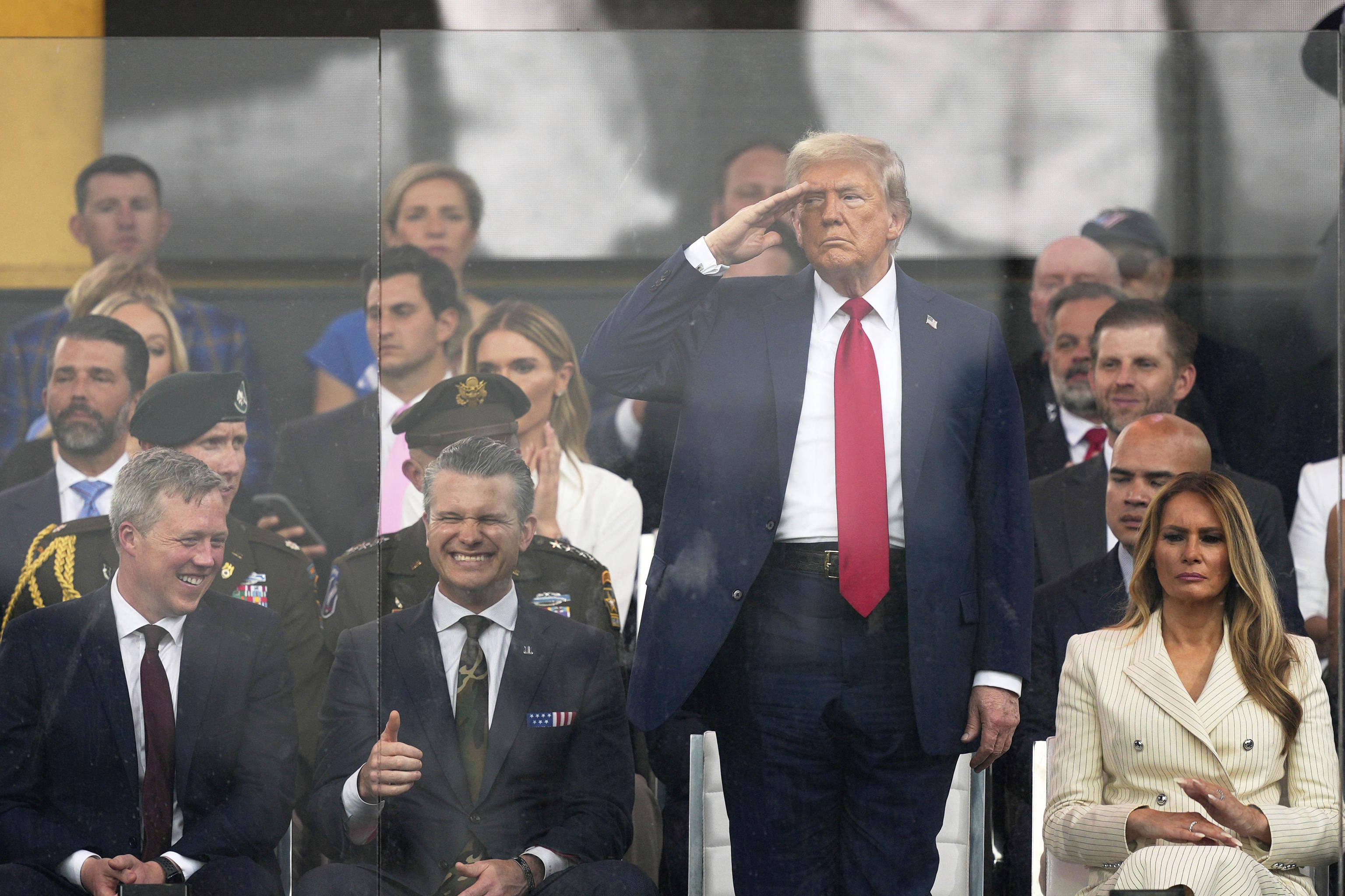 President Donald Trump salutes as attends a military parade.