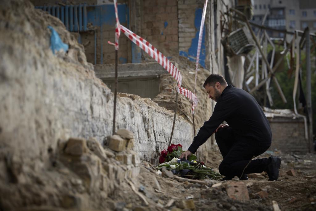 Presidential Press Office, Ukrainian President Volodymyr Zelenskyy lays flowers at the site of Russia's