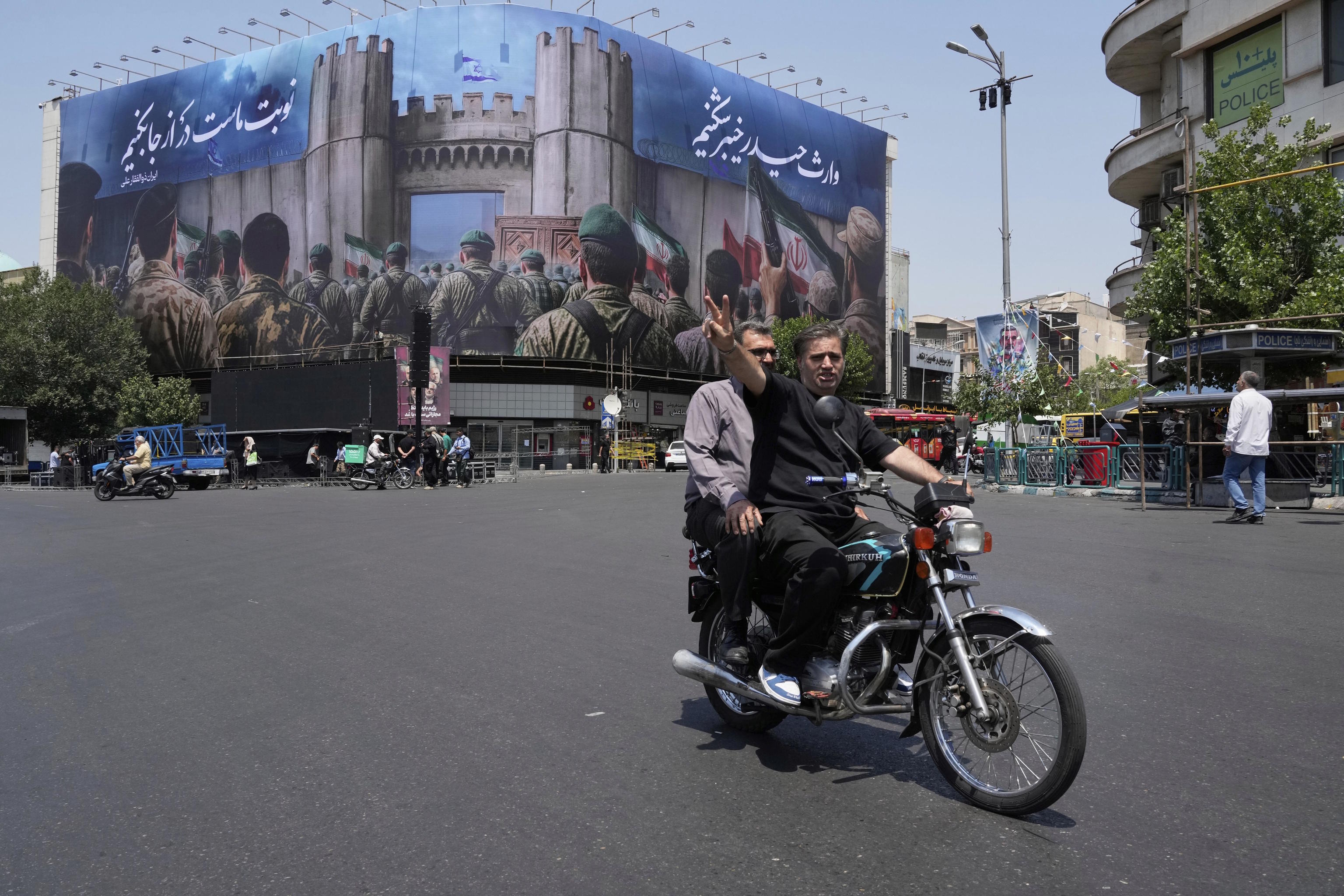A man makes the victory sign at the Islamic Revolution Square in Tehran.