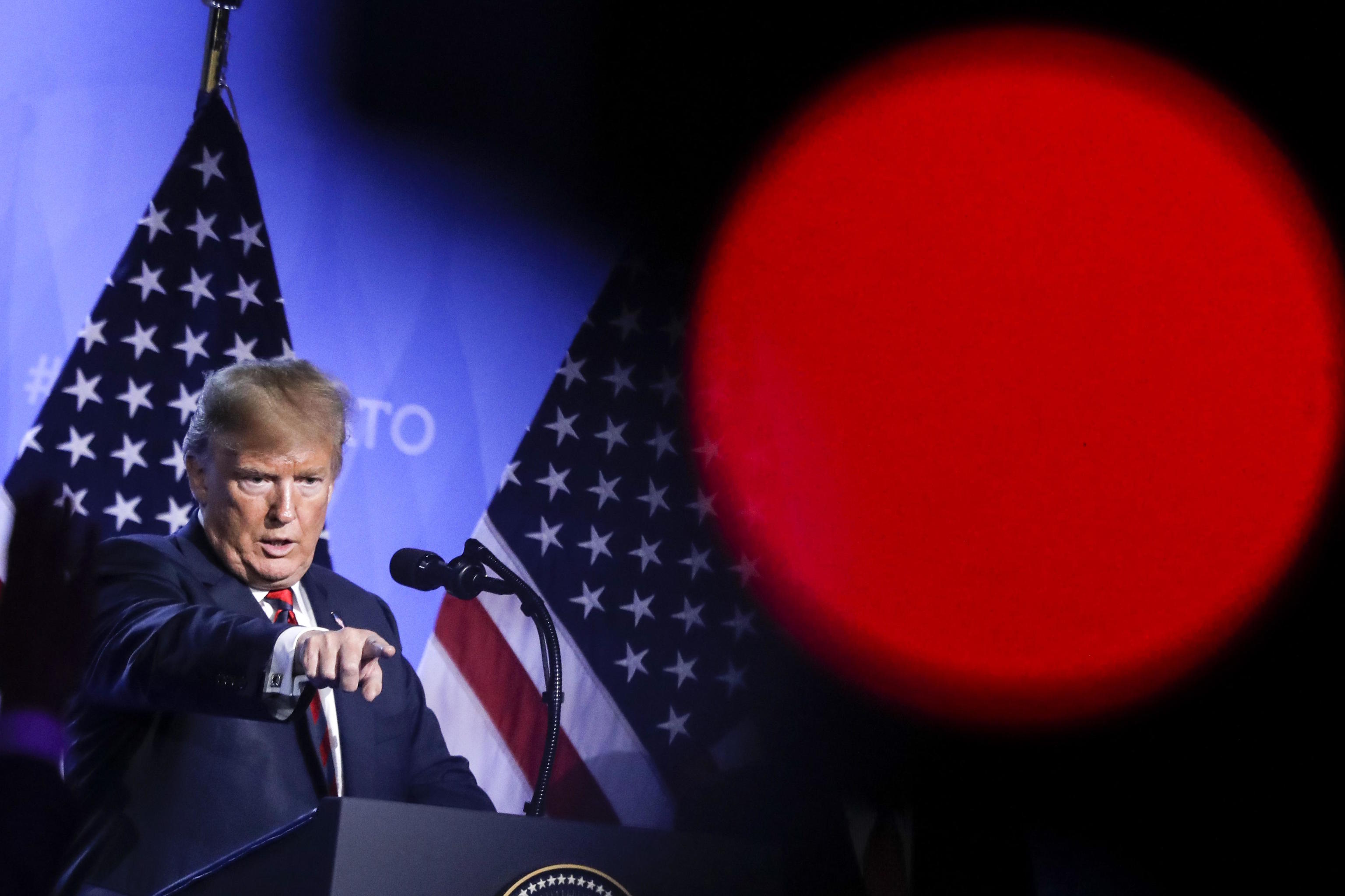 President Donald Trump addresses a news conference.