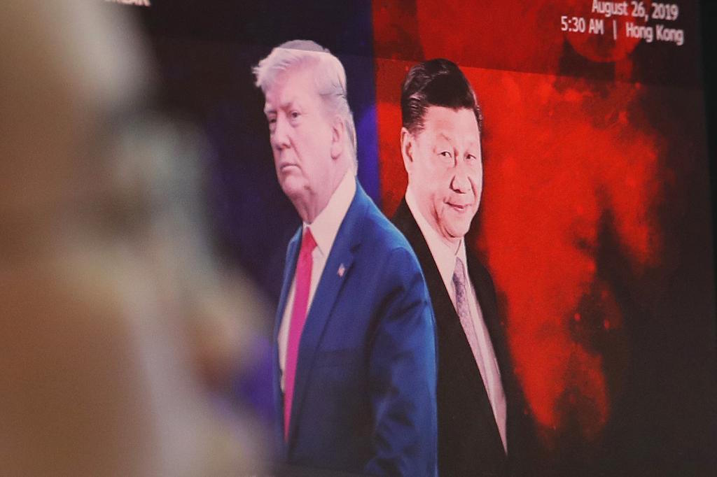 Xi Jinping and Donald Trump at the foreign exchange dealing room of the KEB Hana Bank headquarters in Seoul.