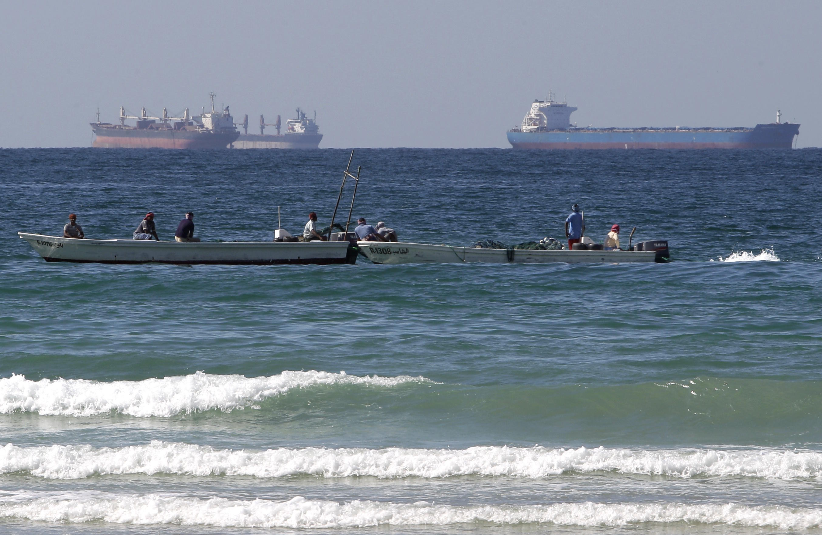 2012 file photo, fishing boats are seen in front of oil tankers south of the Strait of Hormuz.