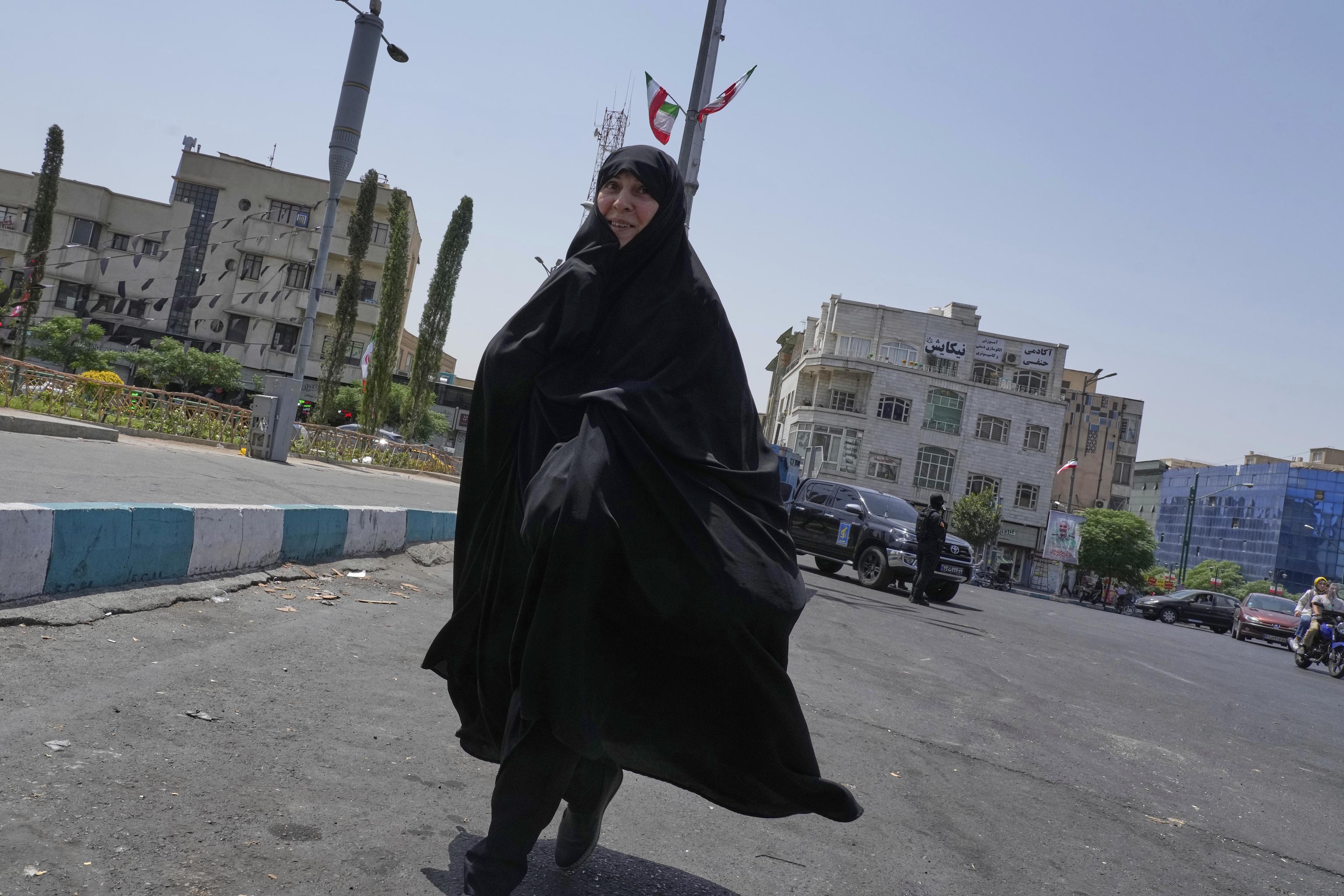 An Iranian woman walks on Enqelab-e-Eslami (Islamic Revolution) square in downtown Tehran.