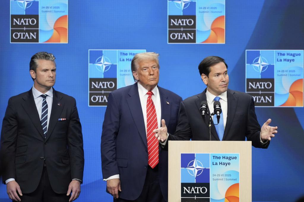 Secretary of State Marco Rubio gestures standing with President Donald Trump and Defense Secretary Pete Hegseth