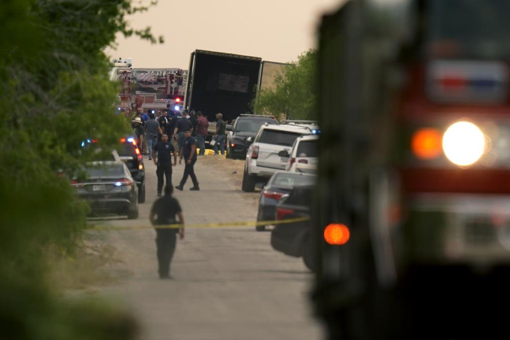 Body bags lie at the scene where a tractor trailer with multiple dead bodies was discovered