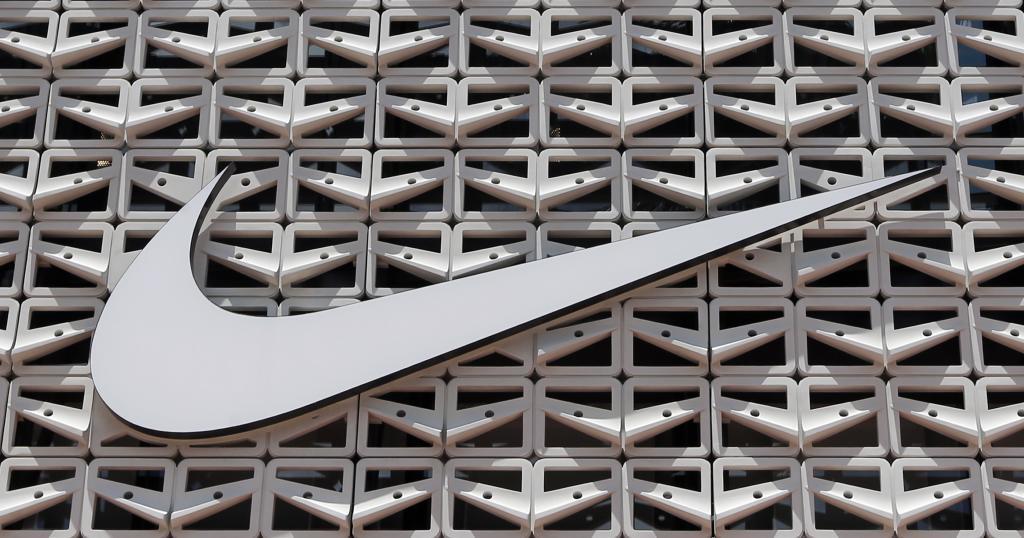 The Nike logo is shown on a store in Miami Beach