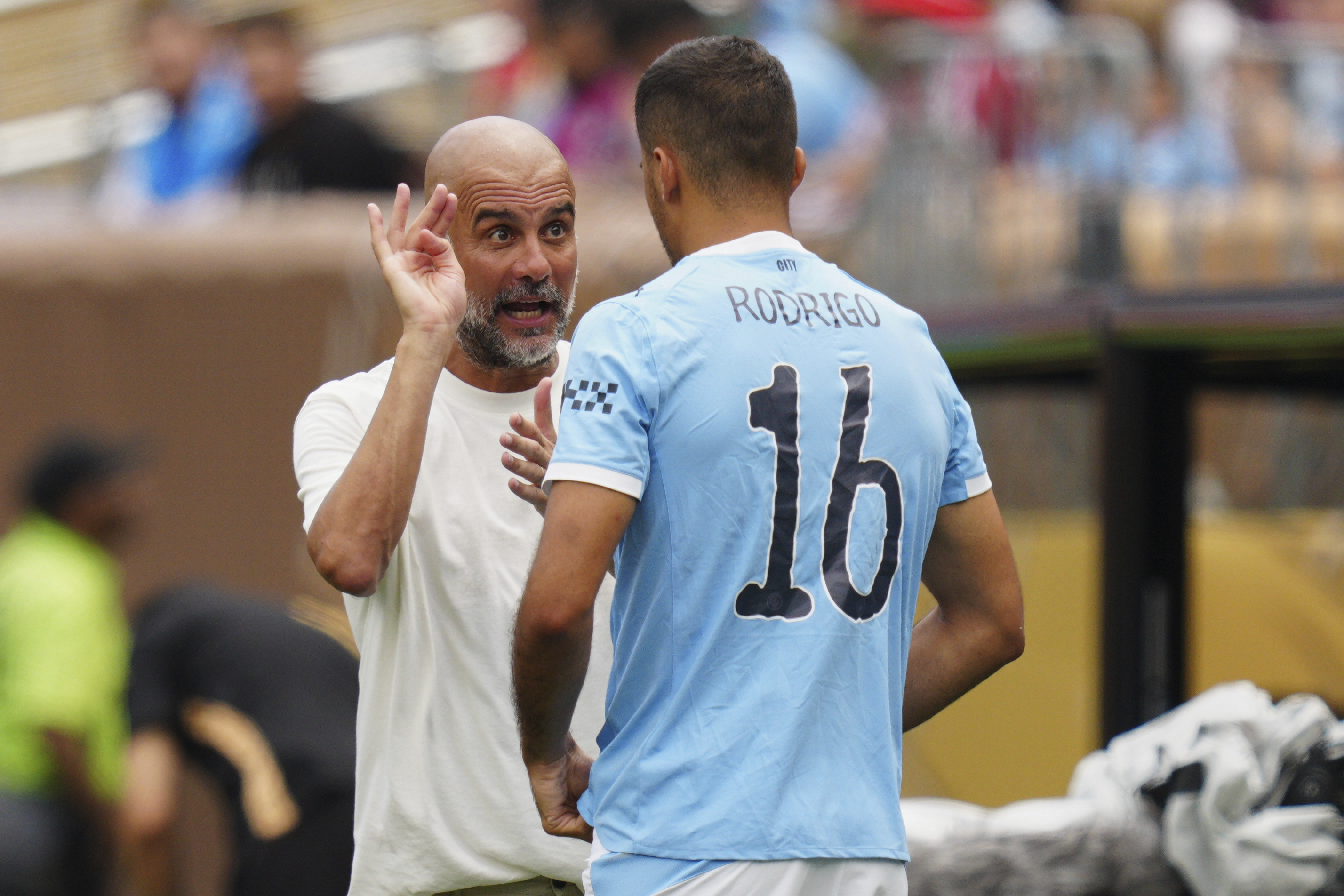 Manchester City manager Pep Guardiola talks to Rodri during the Club World Cup.