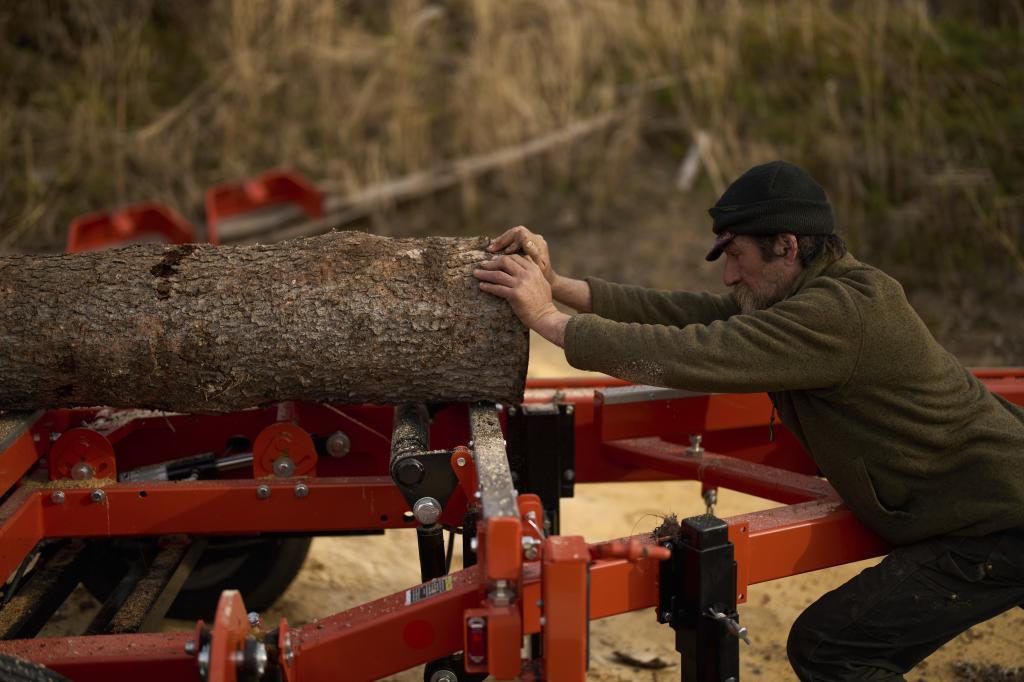 Jake Pogrebinsky aligns a log on a milling machine