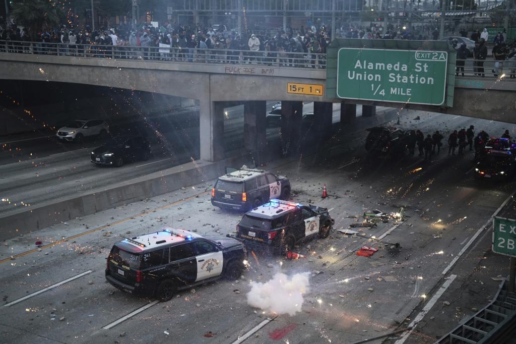 A flash bomb explodes on the 101 Freeway near the metropolitan detention center of downtown Los Angeles,