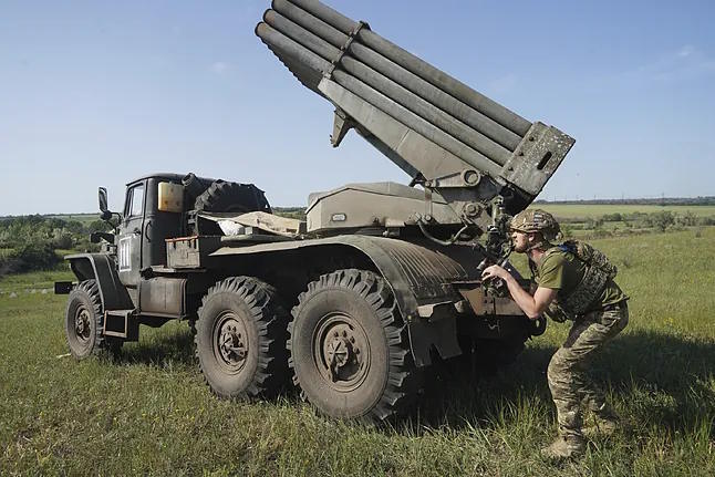 A Ukrainian soldier prepares for rocket launch on the Donetsk front.