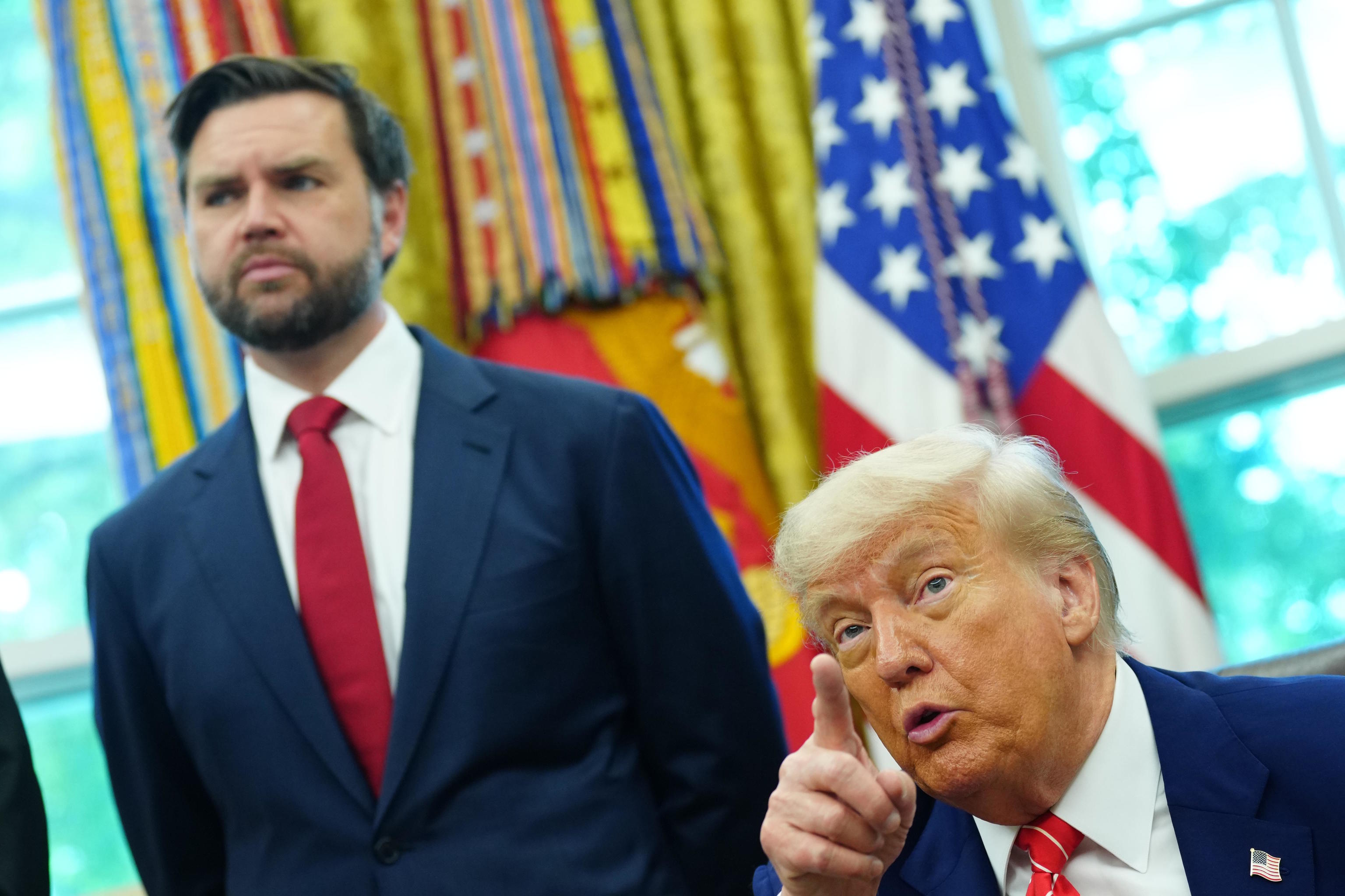 JD Vance looks on as US President Donald J Trump.