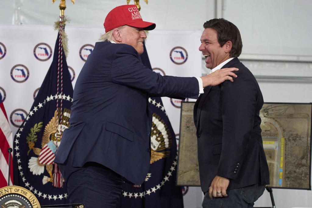 President Donald Trump talks with Gov. Ron DeSantis,