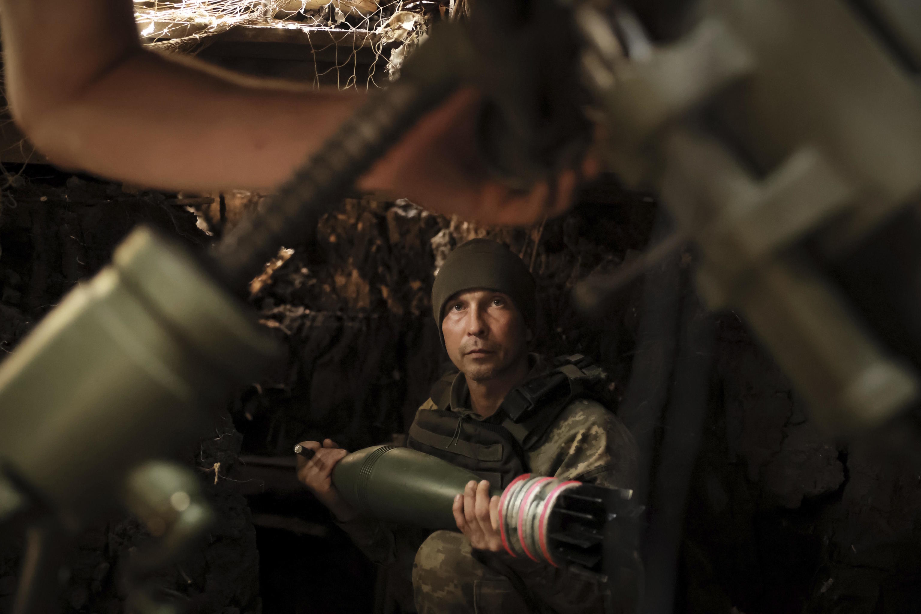 A soldier fires a 120 mm mortar at Russian army positions near Chasiv Yar in Donetsk.