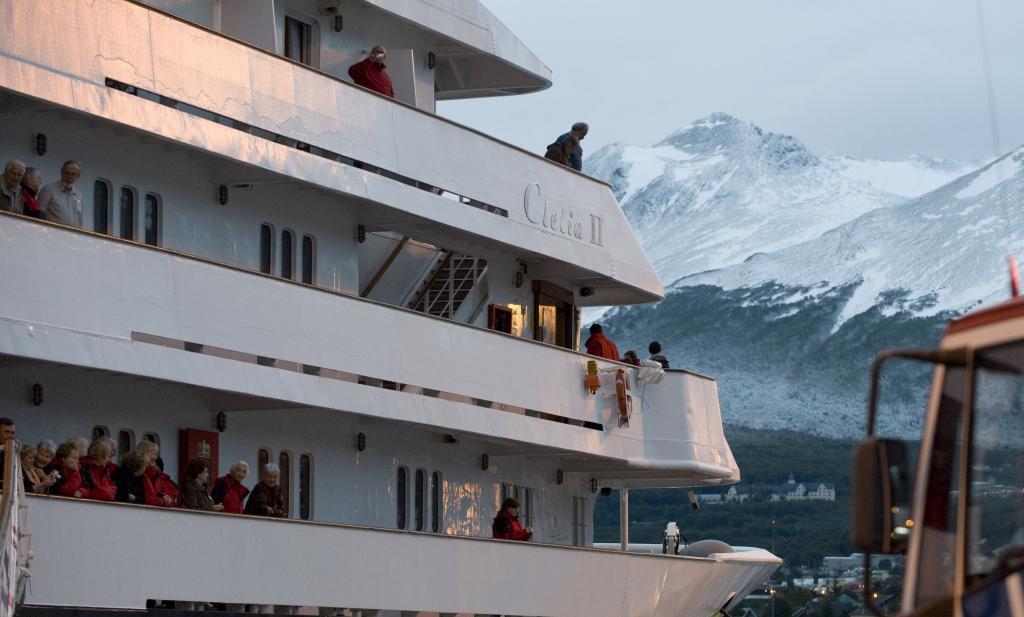 Passengers stand on the deck of the Greek-owned cruise ship 'Clelia II'