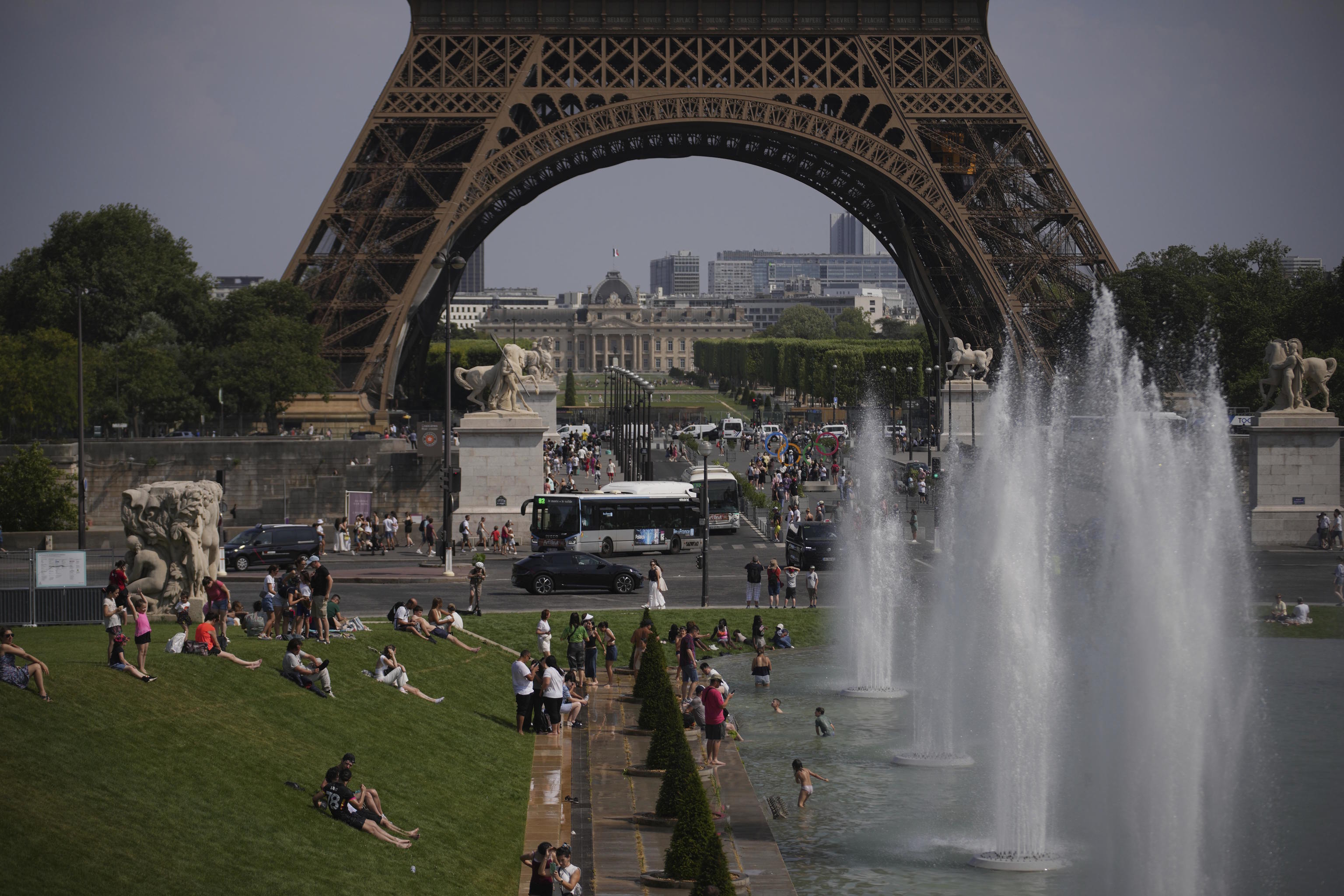 People cool off at Trocadero fountain near the Eiffel Tower.