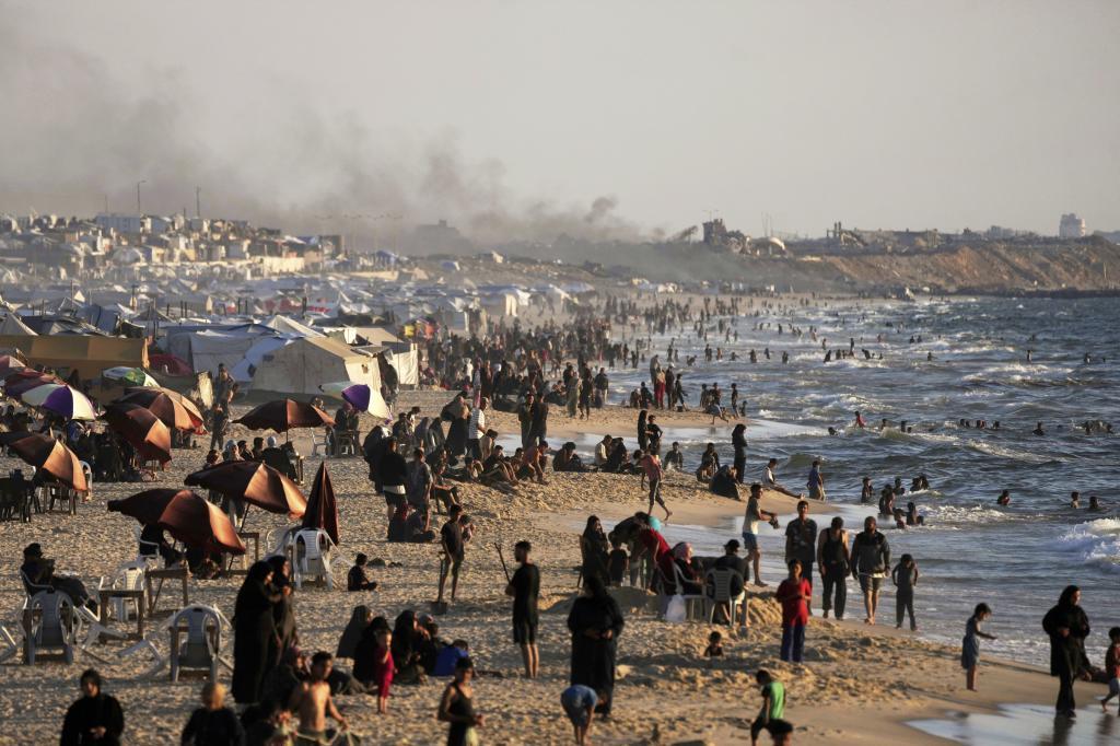 Palestinians on a beach during a heat wave in Gaza City