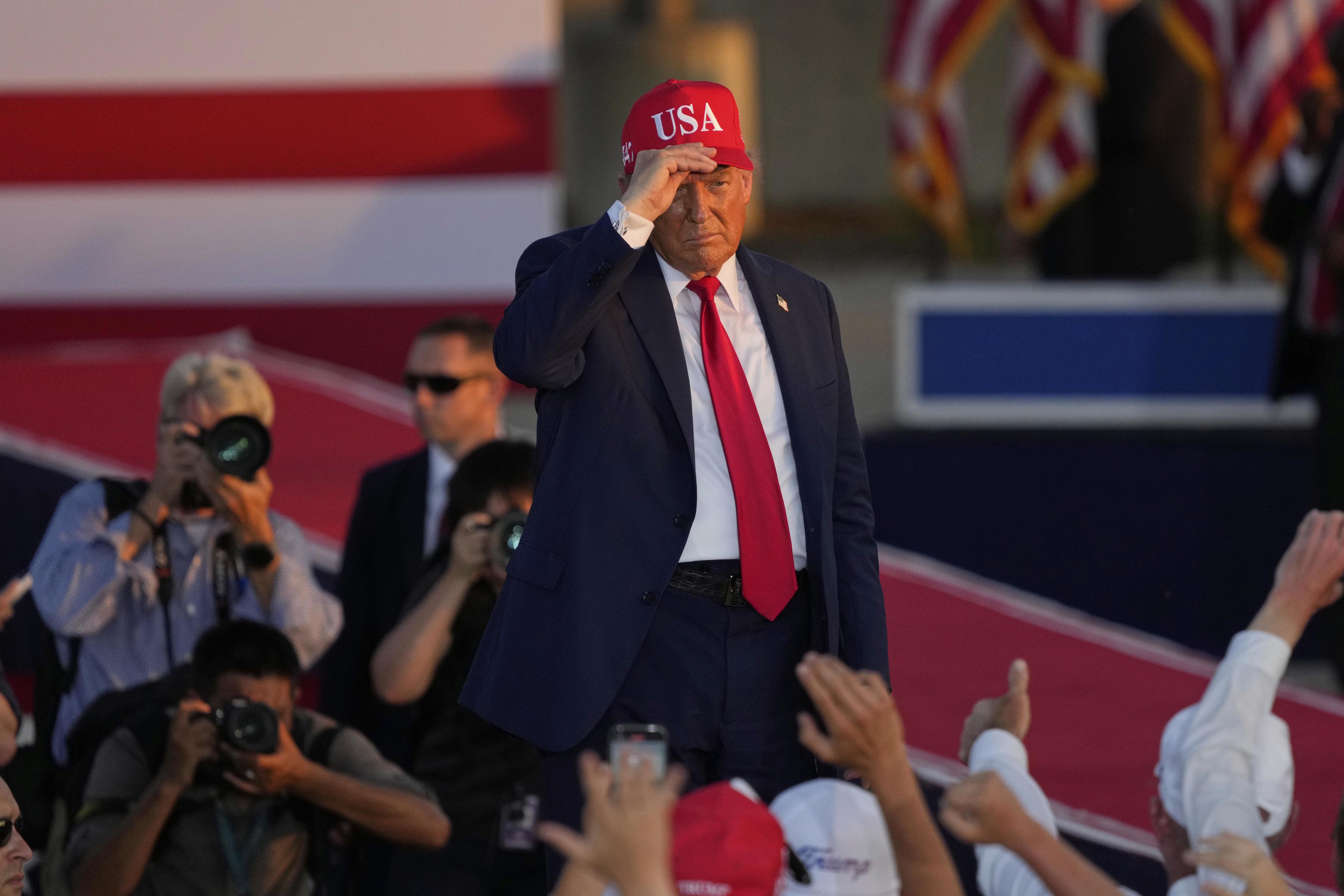 President Donald Trump gestures at a rally at the Iowa State.