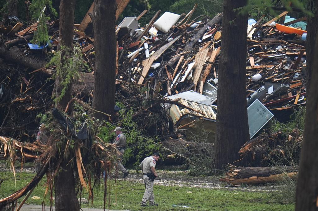 Officials comb through the banks of the Guadalupe River