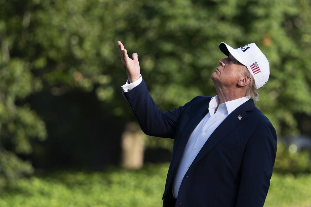 President Donald Trump looks up at the American