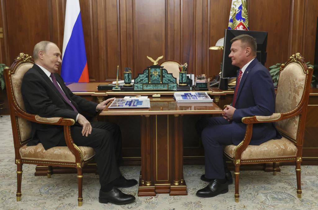 Russian President Vladimir Putin, left, meets with Transport Minister Roman Starovoit at the Kremlin in Moscow
