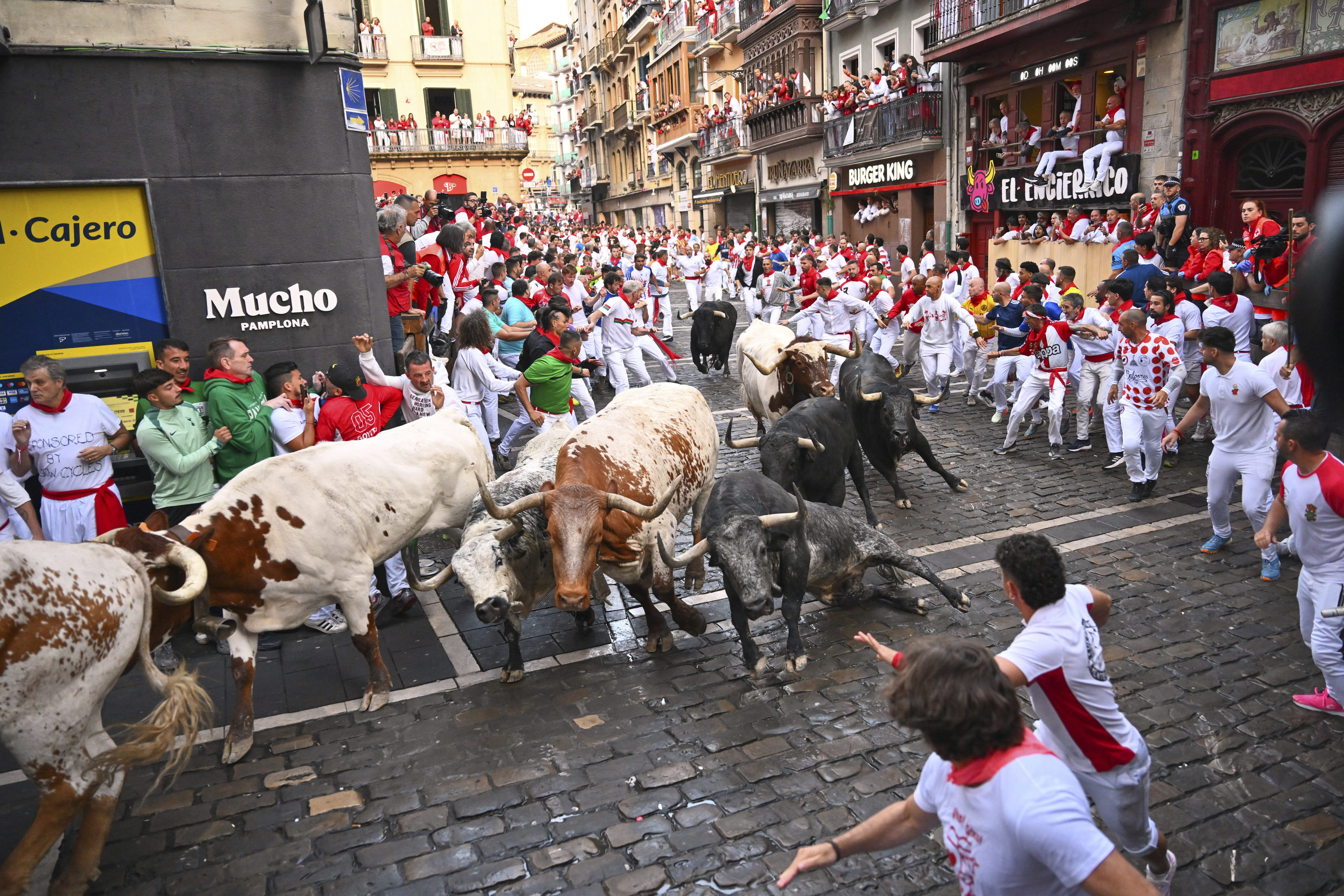 Revelers run with bulls from Cebada Gago ranch during the second day of the running of the bulls at the San Fermn fiestas in Pamplona, Spain.