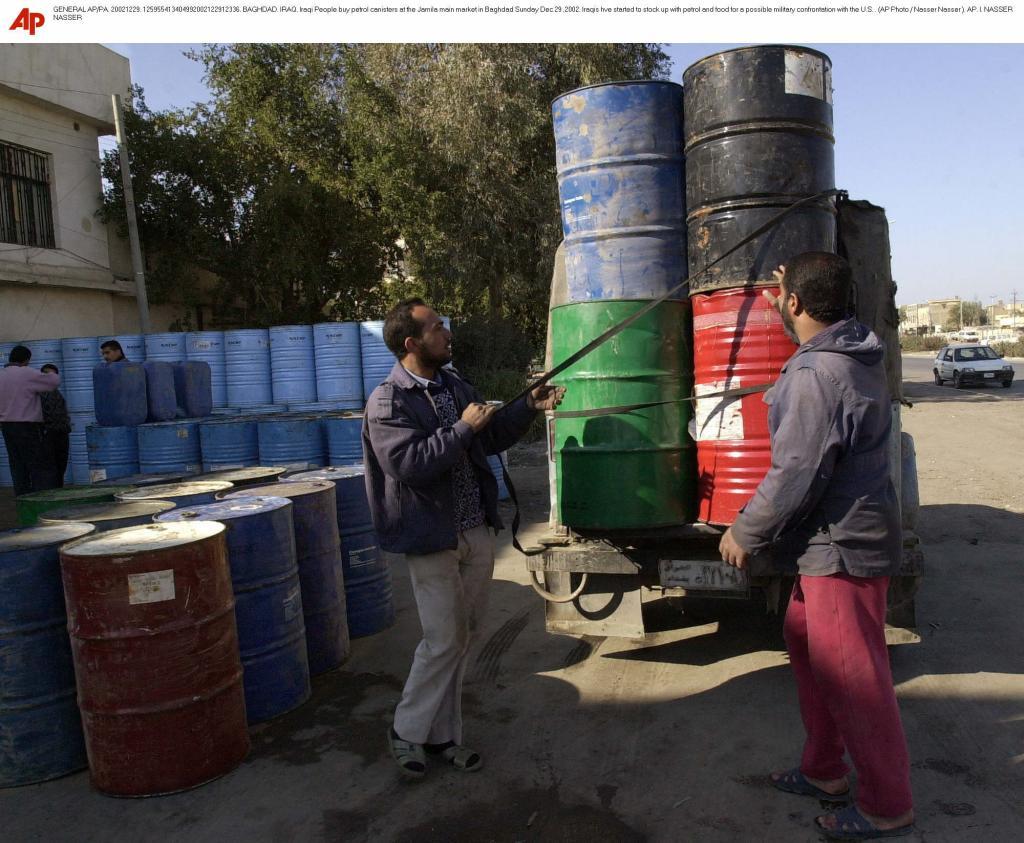 Iraqi People buy petrol canisters at the Jamila main market in Baghdad