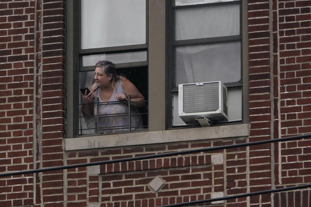 A woman looks out her window