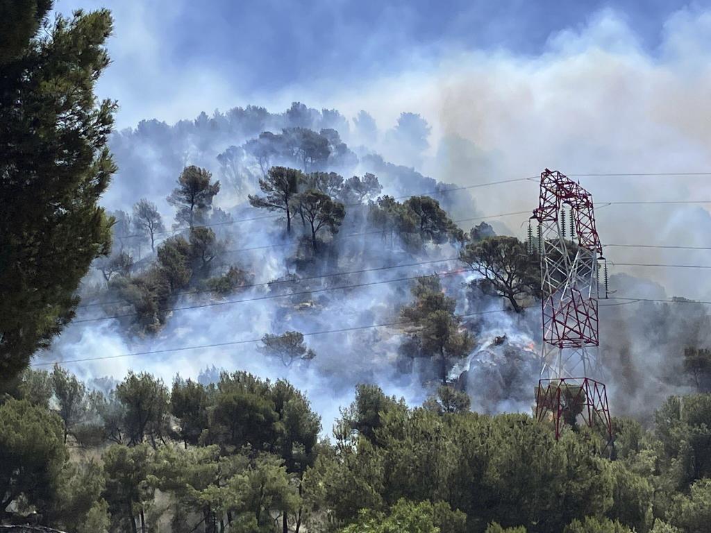 Smoke rises during a wildfire in Pennes-Mirabeau, near Marseille