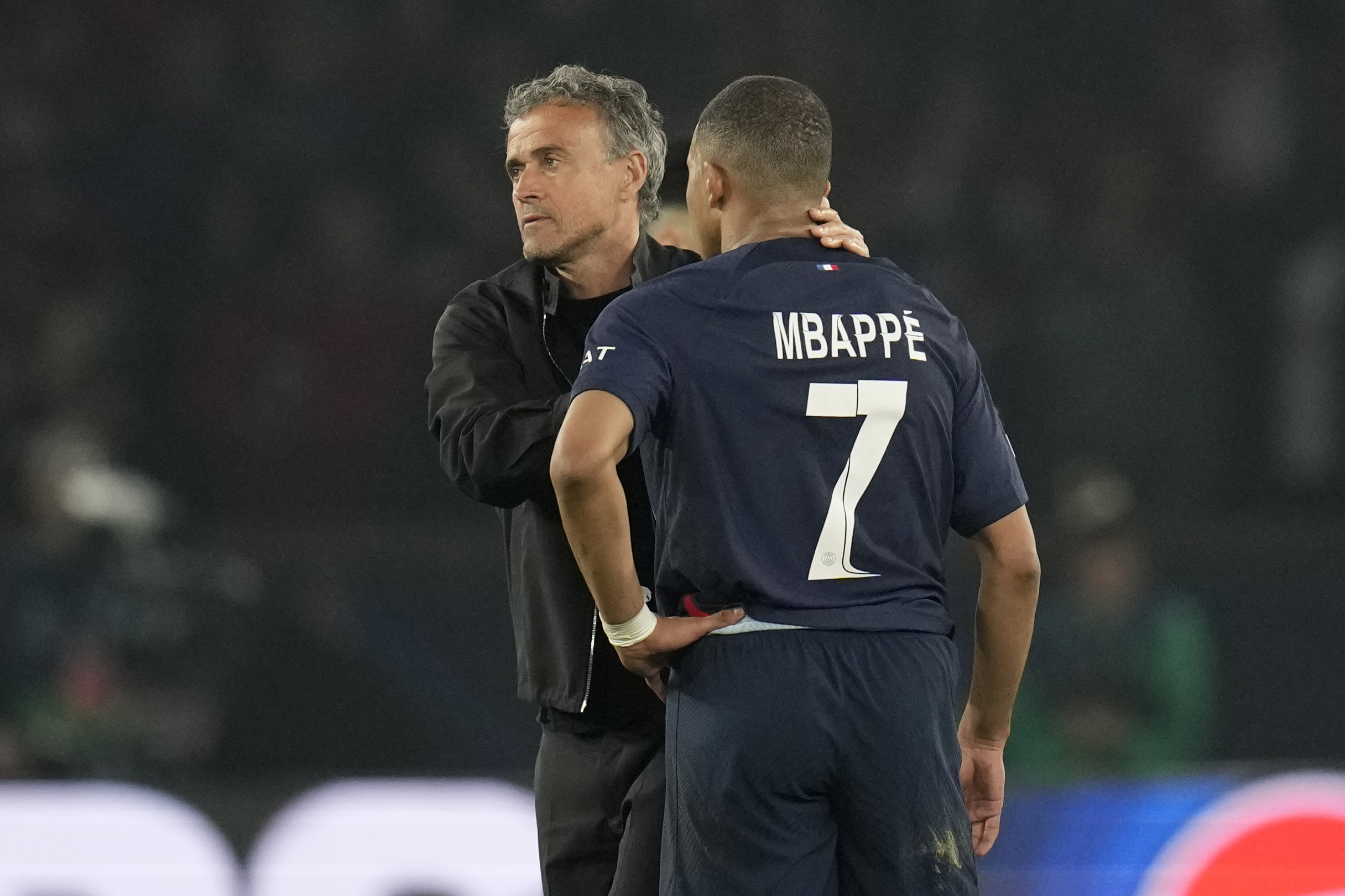 PSG's head coach Luis Enrique, left, comforts PSG's Kylian Mbappe.