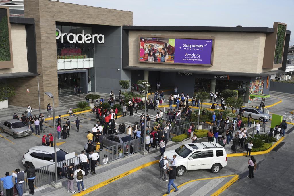 People gather outside of a shopping mall after an earthquake in Guatemala City