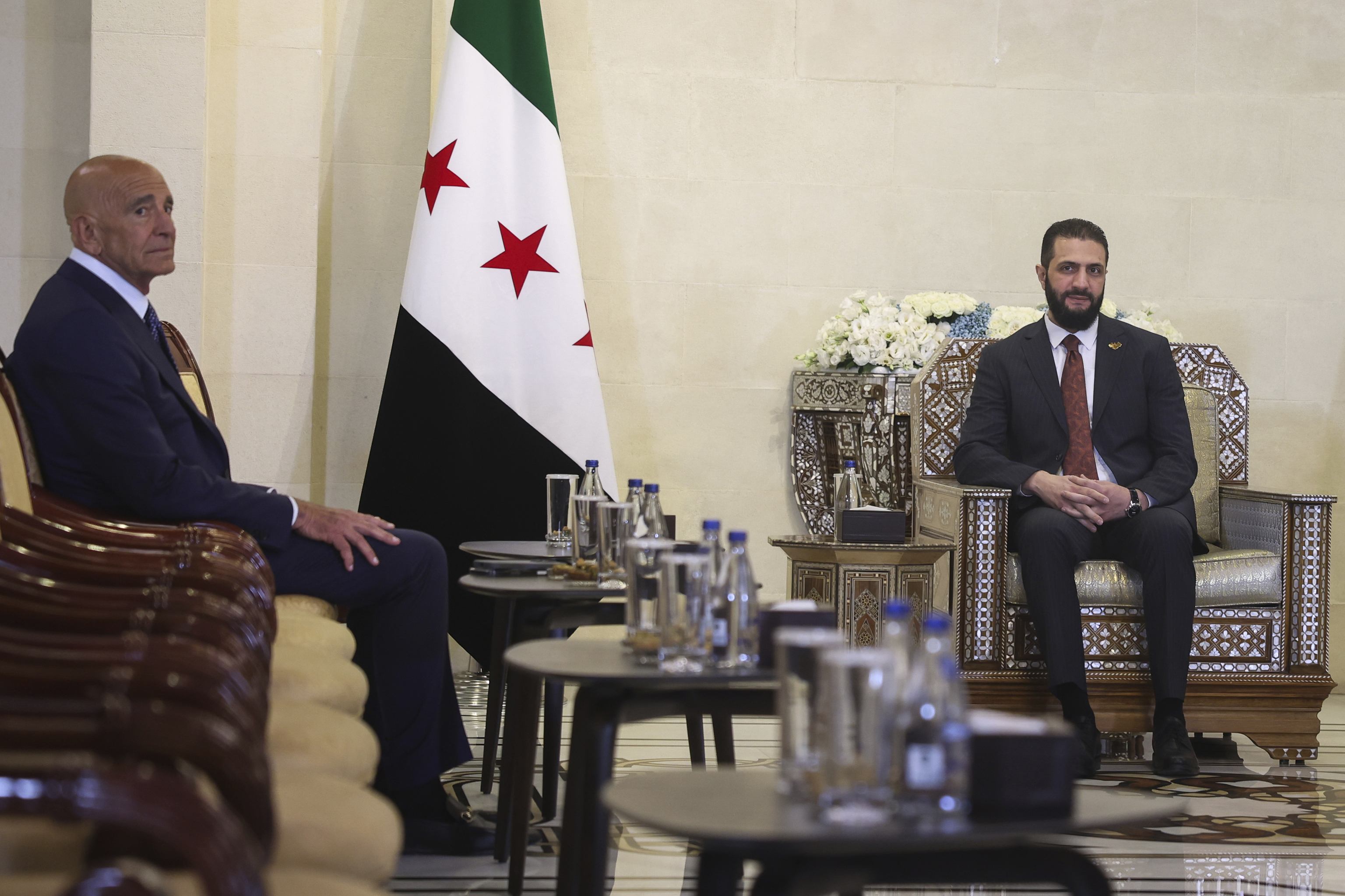 Syria's interim president, Ahmad al-Sharaa, right, with US Ambassador.