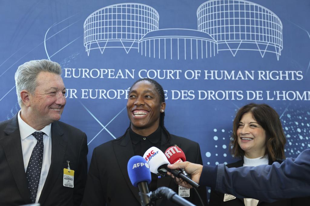 South Africa's Caster Semenya, center, answers reporters with lawyers Gregory Nott, left, and Shona Jolly KC after Semenya