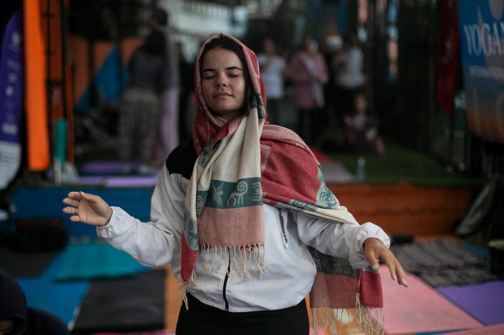 A woman dances during a performance by American vocalist of Hindu devotional music Jeff Kagel