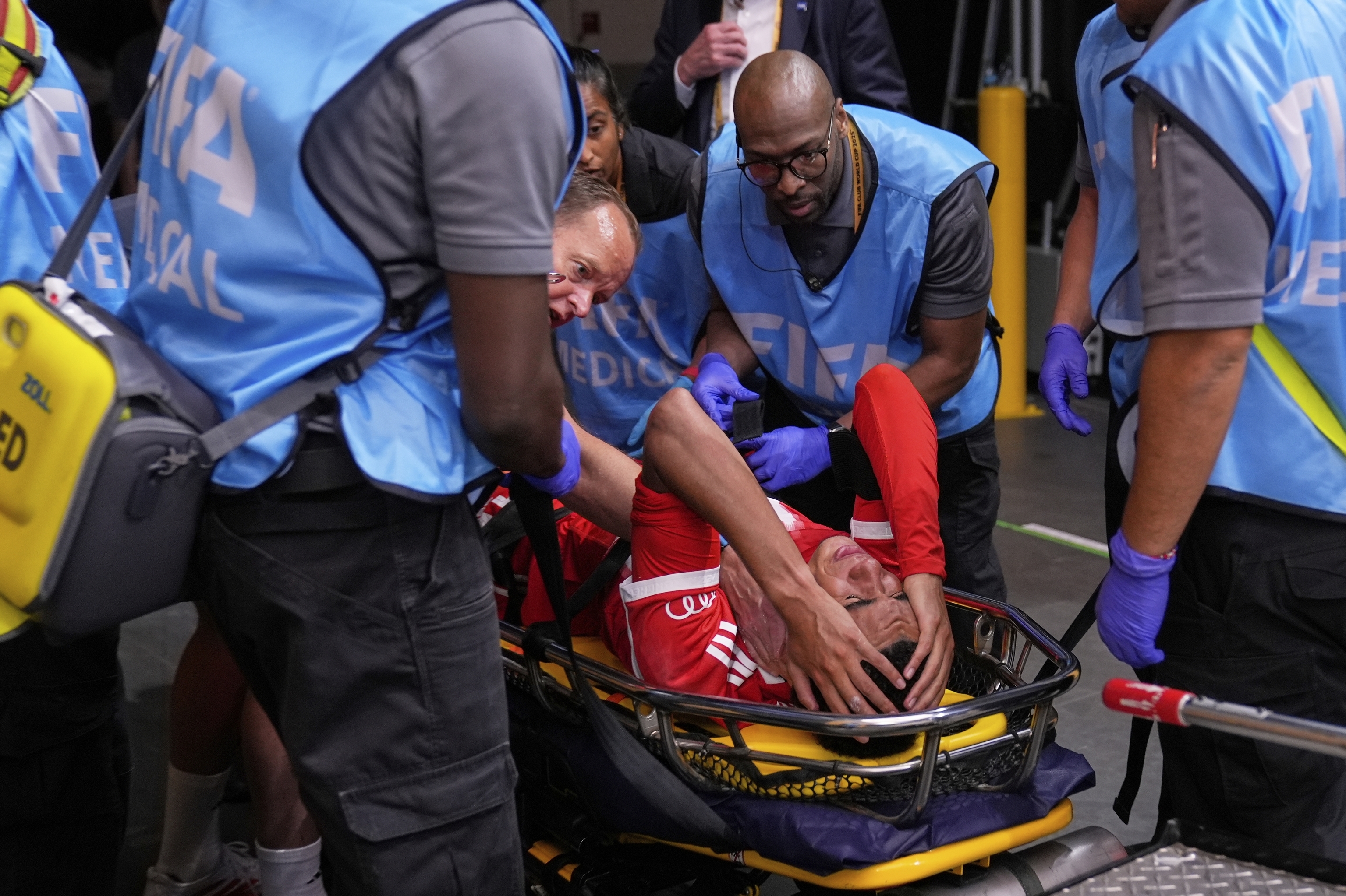Bayern Munich's Jamal Musiala is taken off the field after an injury.