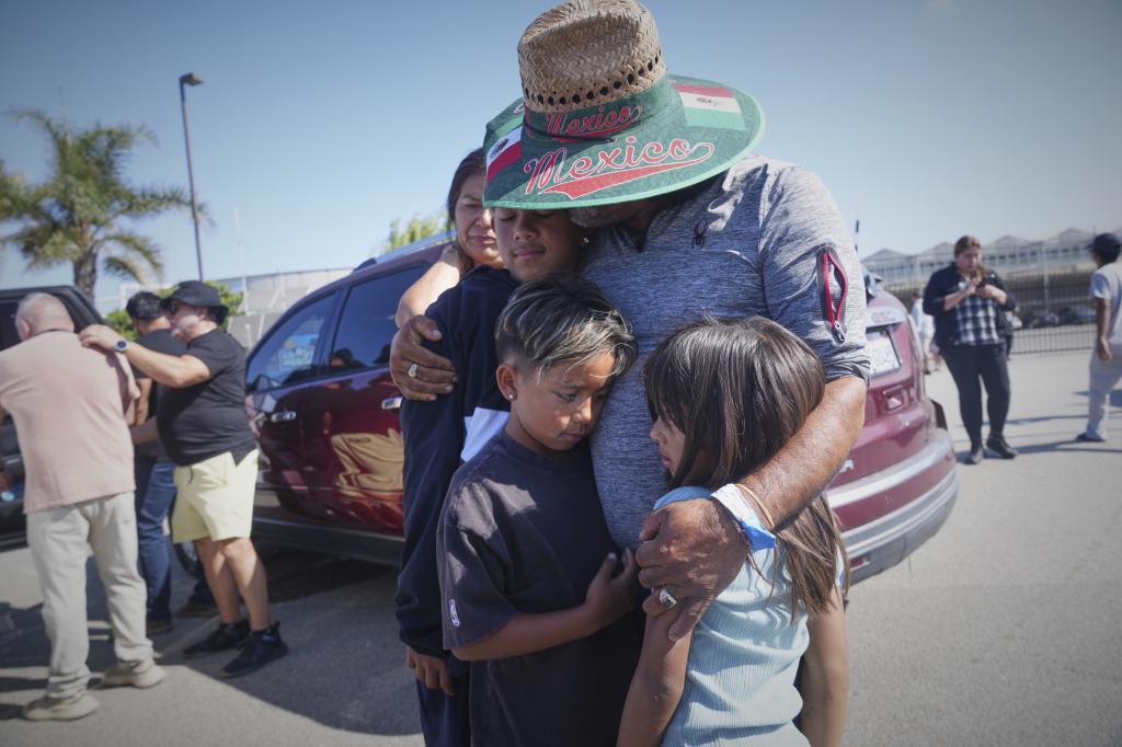 People embrace outside of Glass House Farms.