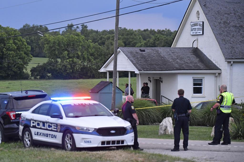 Police stand at the front of the Richmond Road Baptist Church.