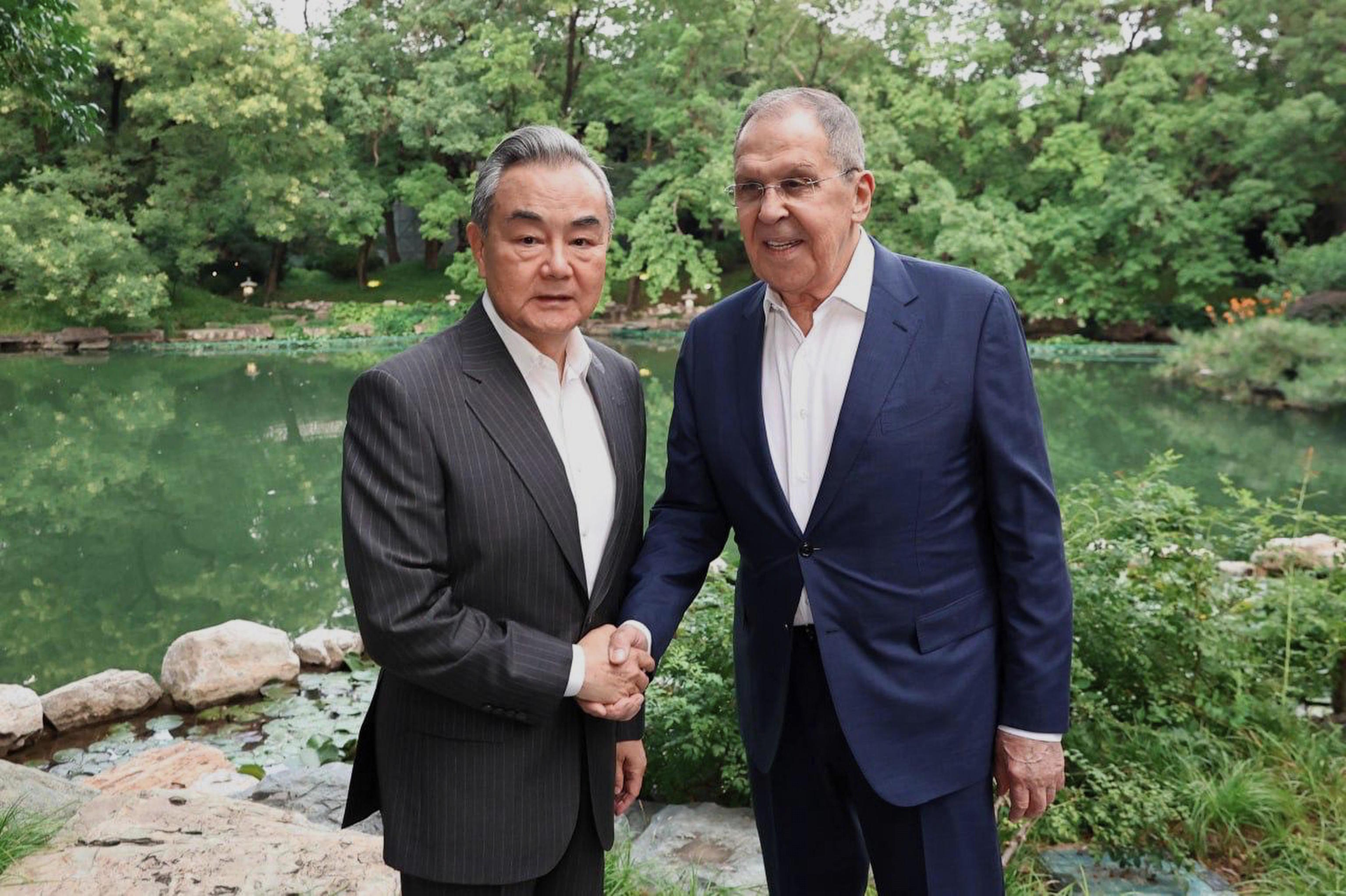 Russian Foreign Minister Lavrov greets his Chinese counterpart, Wang Yi, during their meeting in Beijing.