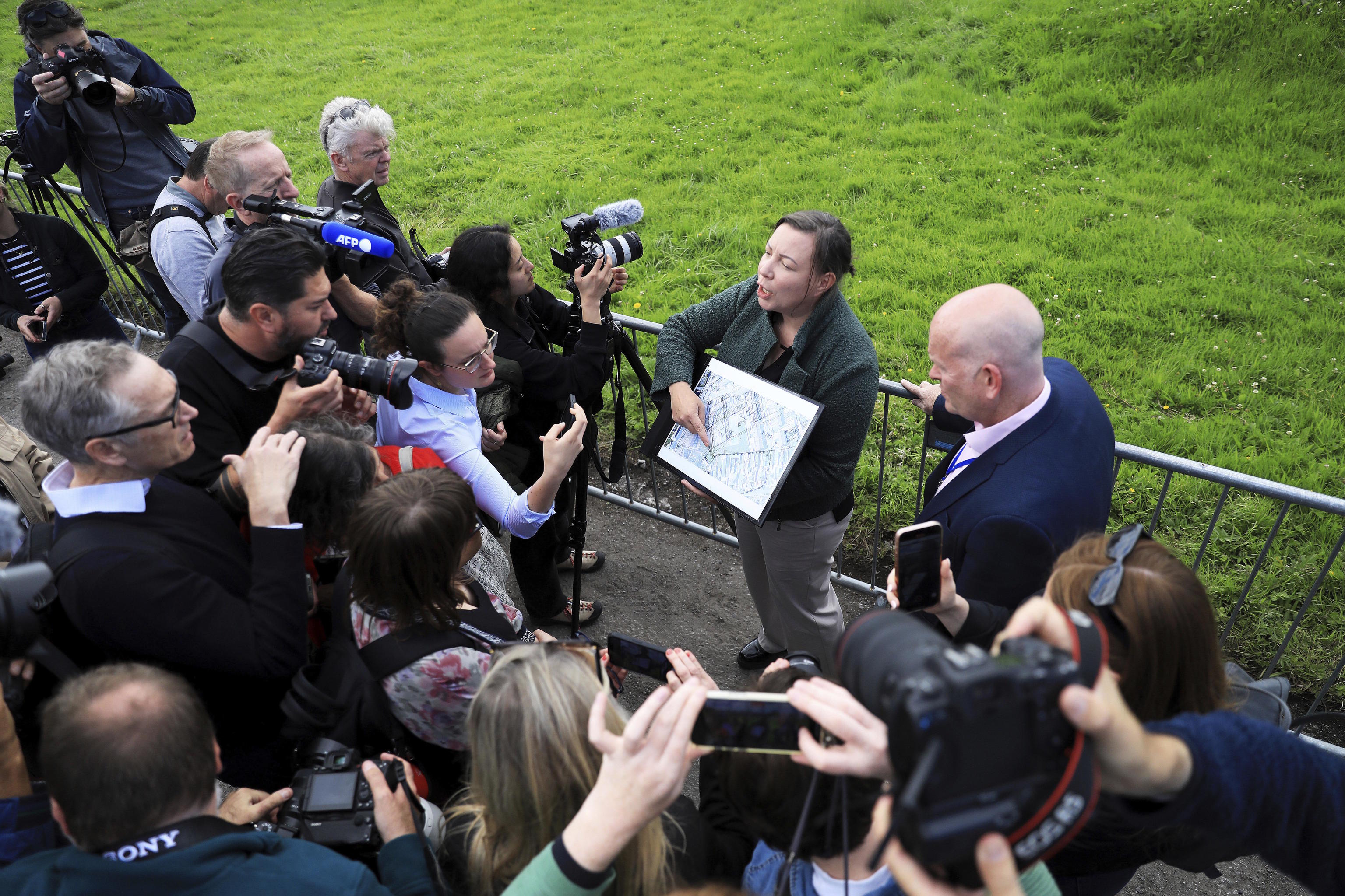 Senior forensic consultant, points to a map of the excavation site in Tuam.