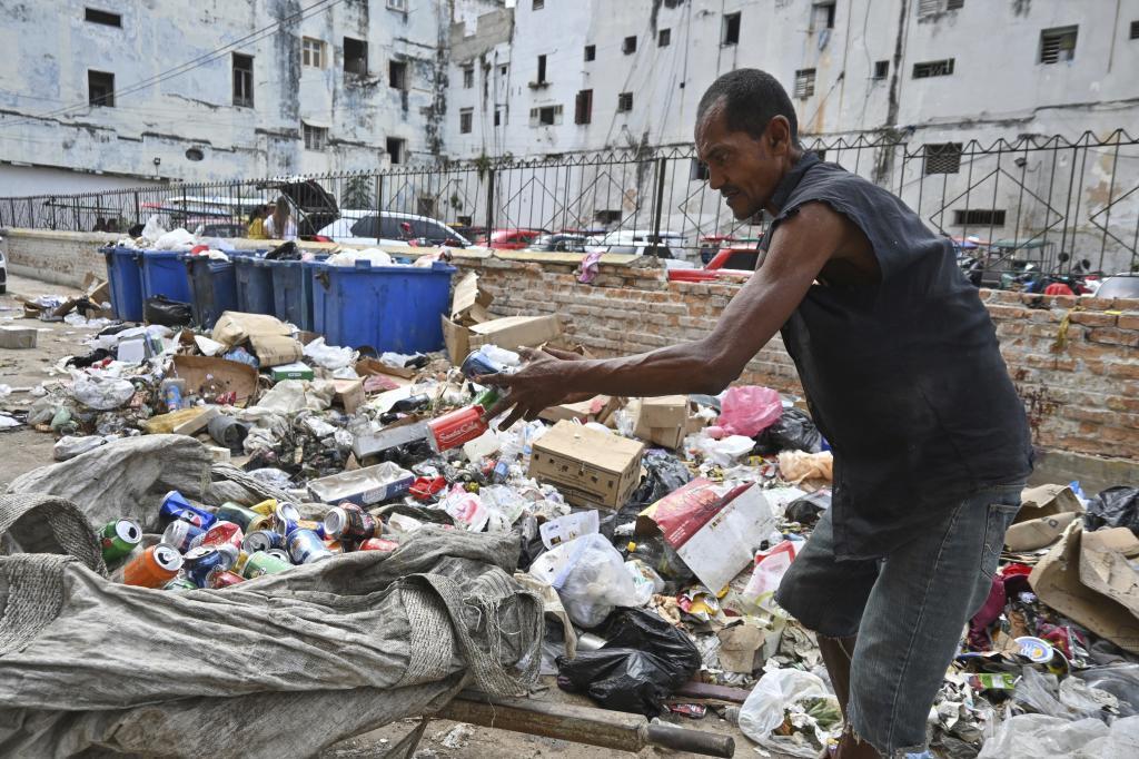 A man culls through garbagen Havana, Cuba.
