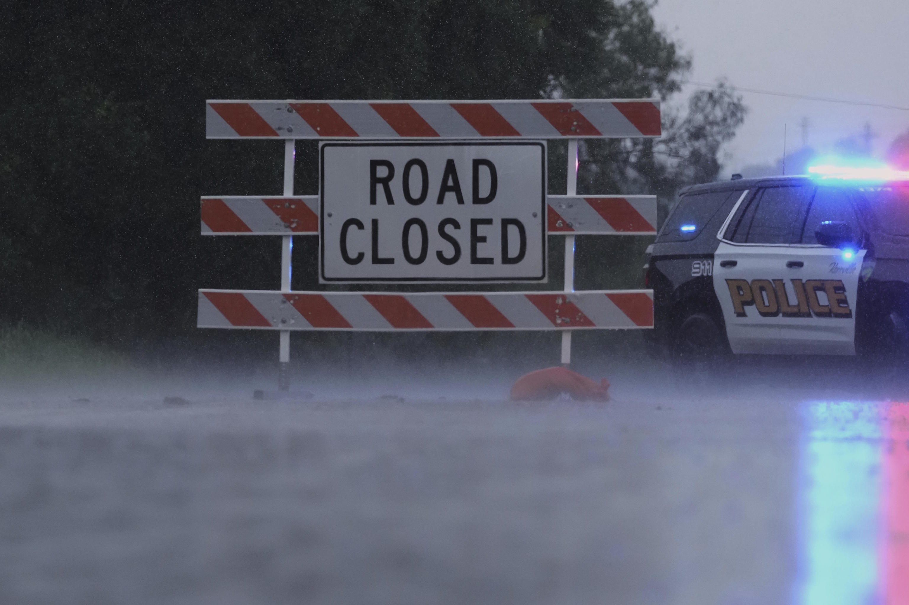 A barricade blocks a road during heavy rains in Texas.