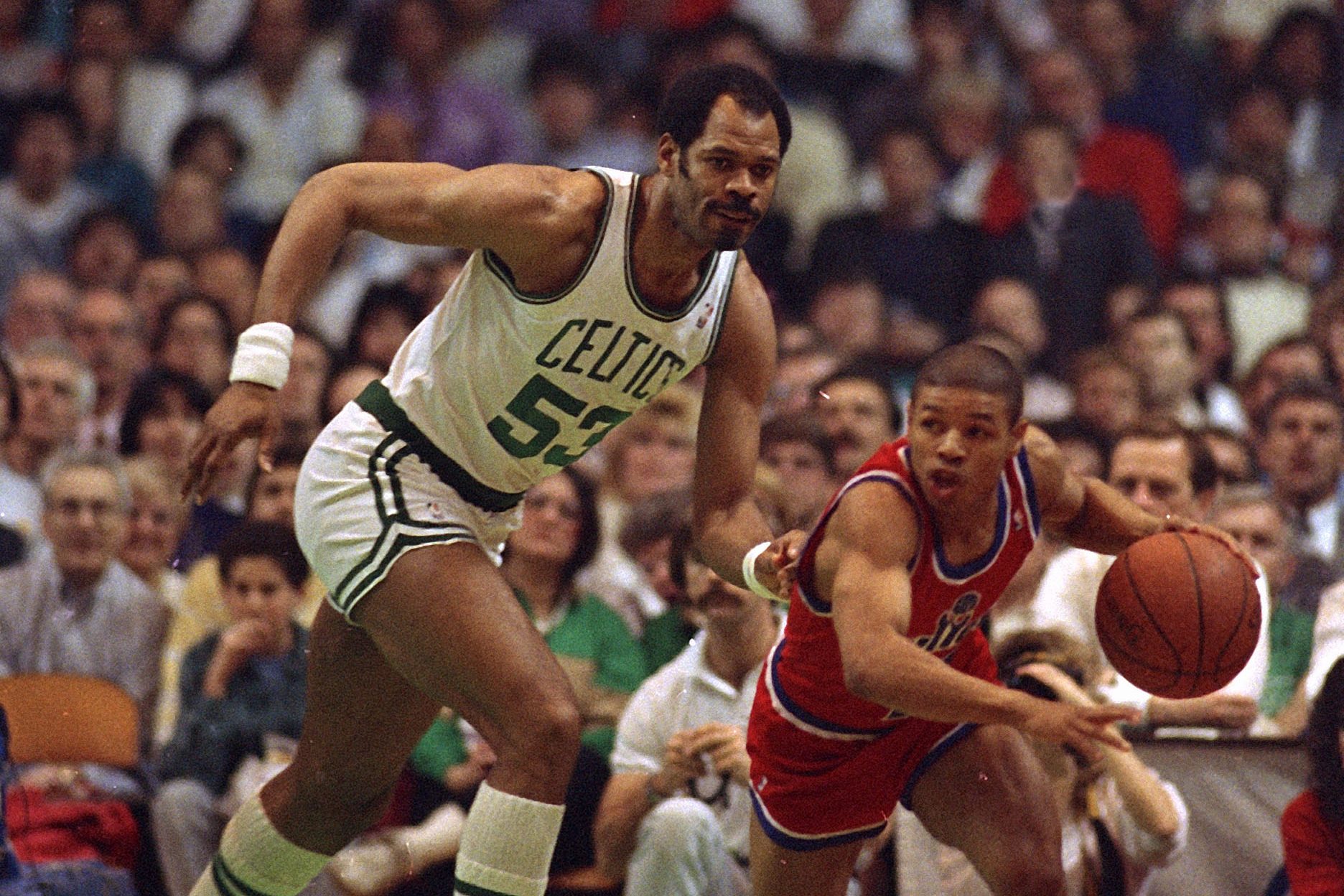 Artis Gilmore, left, tries to catch up with Tyrone Bogues , March 24, 1988