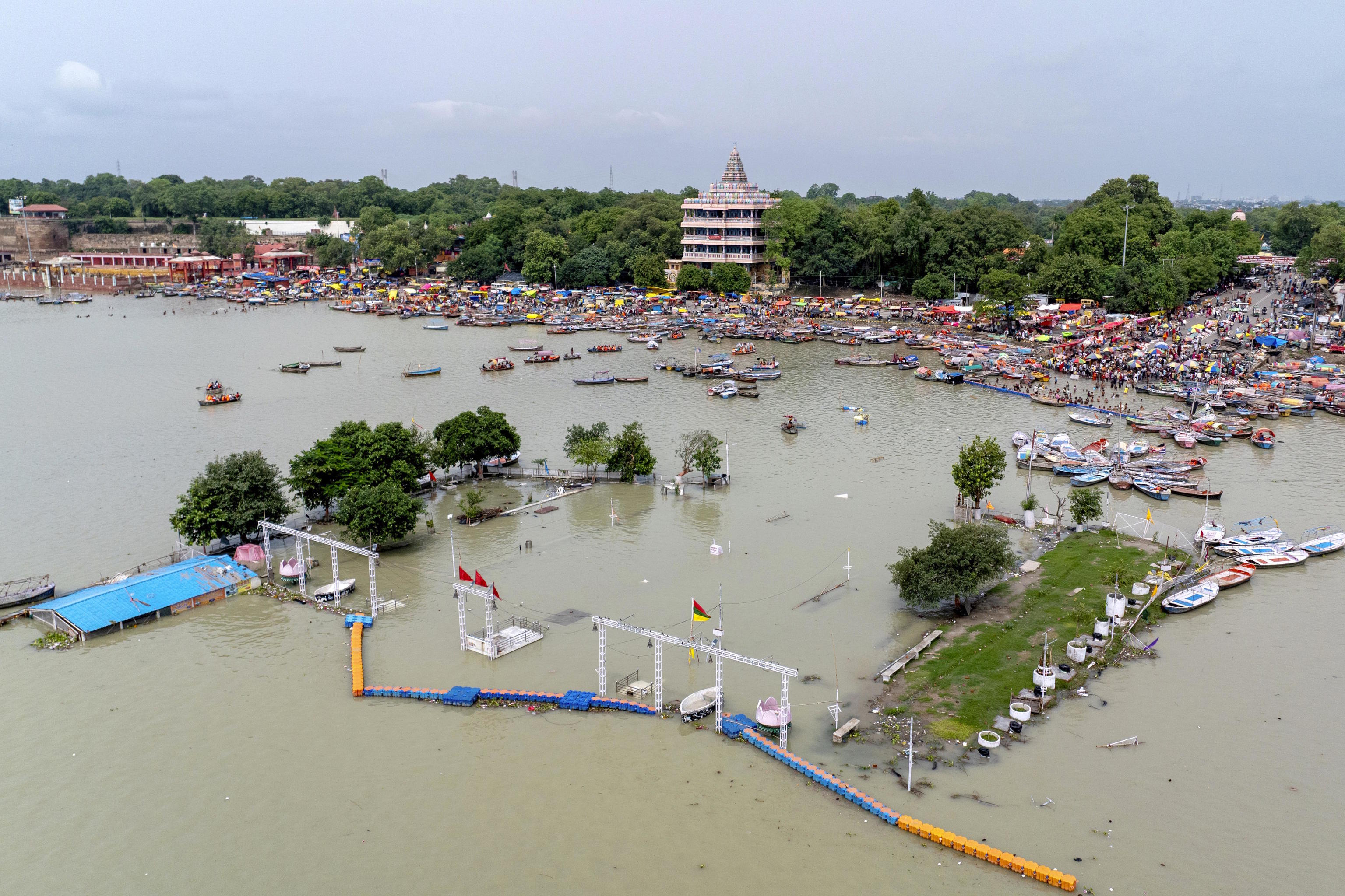 Devotees of the Hindu god Shiva gather to collect holy water from the Ganges River.