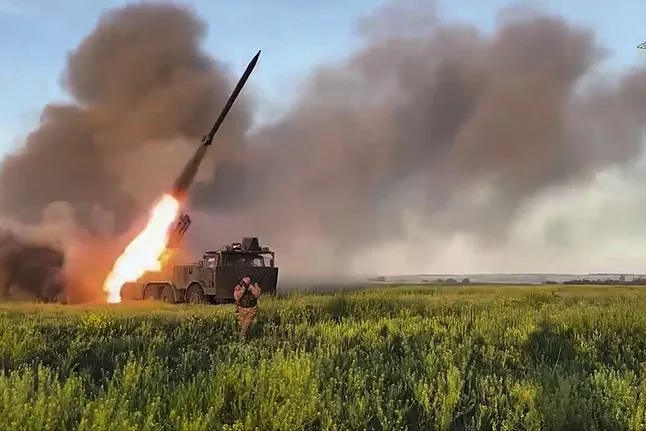 A Russian self-propelled multiple rocket launcher fires towards a Ukrainian position.