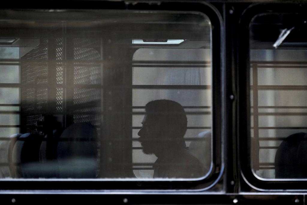A man sits on a bus.
