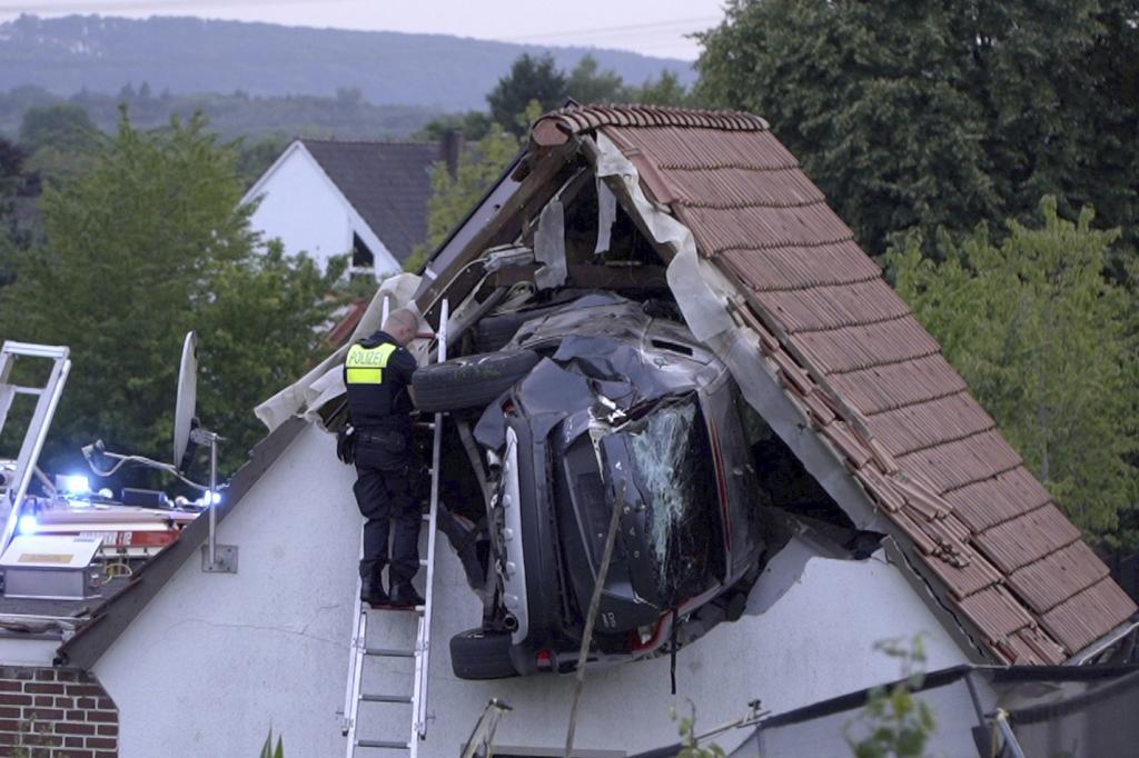 Car crashes into a barn's roof.