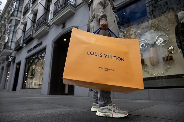 A person with a Louis Vuitton bag.